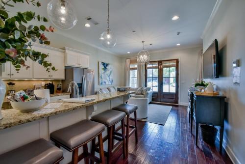 a kitchen with a bar with stools at Bama Getaway in Tuscaloosa