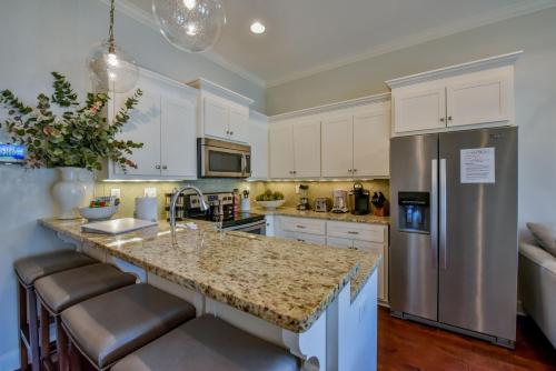 a kitchen with a granite counter top and a refrigerator at Bama Getaway in Tuscaloosa