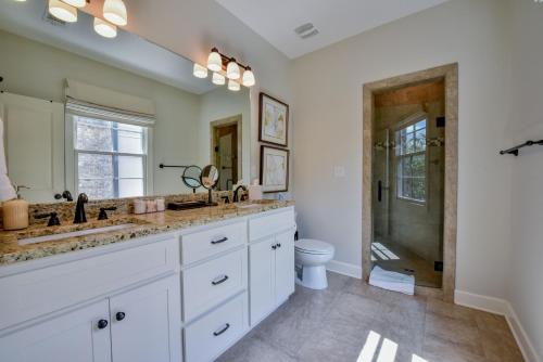 a bathroom with two sinks and a toilet at Bama Getaway in Tuscaloosa