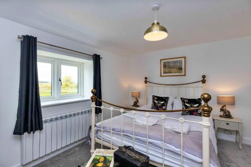 a bedroom with a bed and a window at Finest Retreats - The Warren in Stamford
