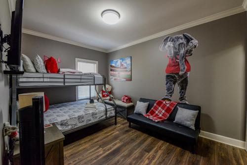 a room with two bunk beds and a couch at Elephant Stomp in Tuscaloosa