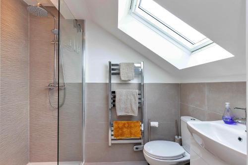 a bathroom with a shower and a toilet and a sink at Finest Retreats - The Holt in Stamford
