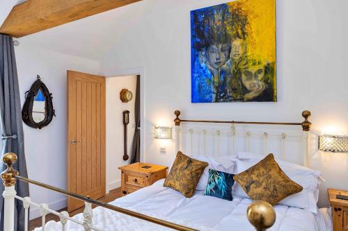 a bedroom with a bed and a painting on the wall at Finest Retreats - The Sett in Stamford
