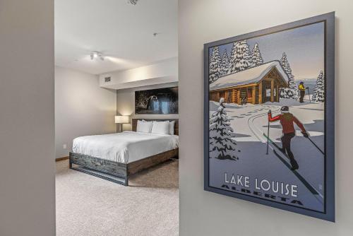 a hotel room with a poster of a ski lodge at White Spruce Condo by Gordon Property Management in Canmore