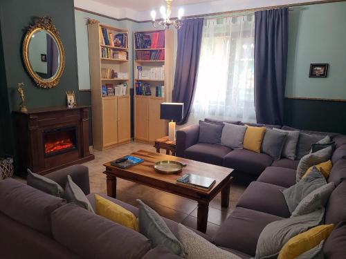 a living room with a couch and a table at La Maison des Rêves - Bran in Bran