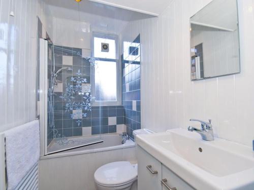 a bathroom with a toilet and a sink and a shower at Seabreeze in North Berwick