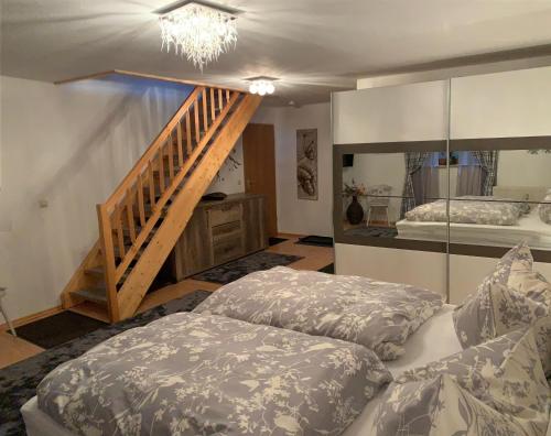 a living room with a bed and a staircase at Ferienresidenz Am Hauchen in Reit im Winkl