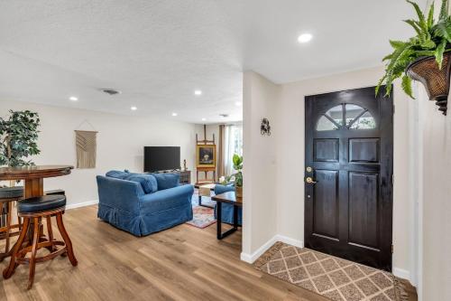 a living room with a blue couch and a door at La Niña Nokomis Beach & Venice Island Fenced In Yard in Nokomis