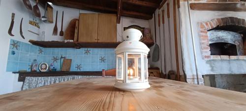 a glass lantern sitting on top of a wooden table at Casa Sartiglia in Oristano