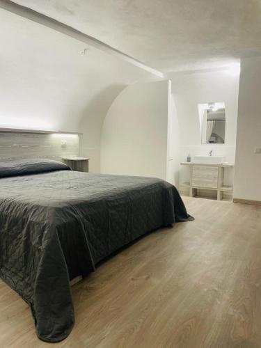 a bedroom with a large bed and a desk at Appartamenti Sole e Luna in Tropea