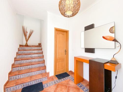 a staircase in a house with a wooden door at Spacious villa in Portimão ideal for families #1938 in Portimão