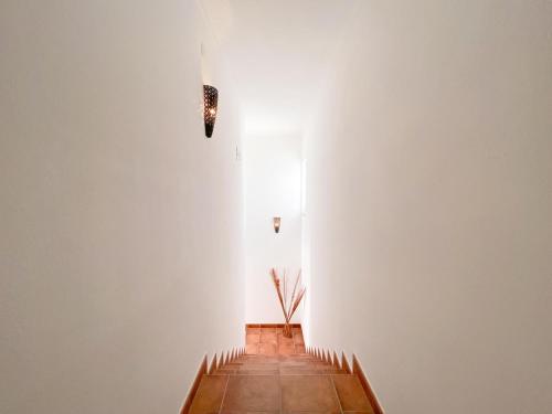 a hallway with a white wall and a wooden floor at Spacious villa in Portimão ideal for families #1938 in Portimão