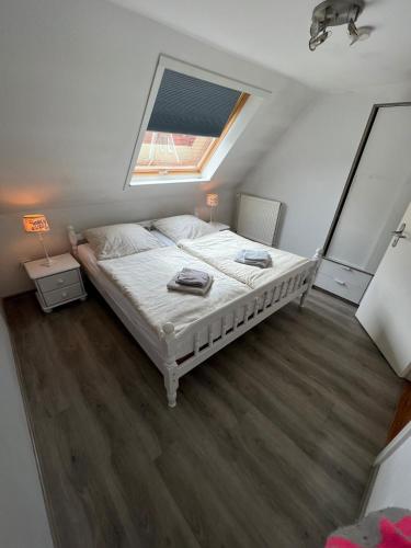 a bedroom with a large bed with a window at Ferienwohnung Glück in Olsdorf