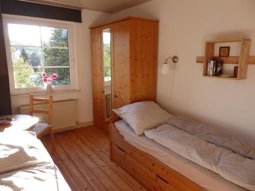 a bedroom with a bed and a cabinet and a window at Ferienwohnung zum Riesenlöffel in Arnstadt