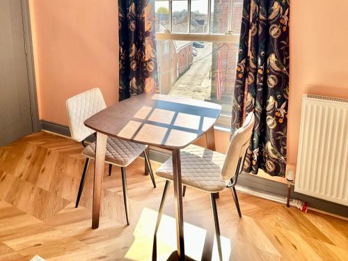 a table and chairs in a room with a window at The Bradley in Market Weighton