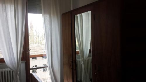 an open door to a window with a view at B&B Casa Mancini in Rimini