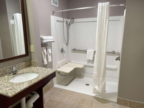 a bathroom with a shower and a toilet and a sink at Motel 6 West Columbia SC Airport in West Columbia
