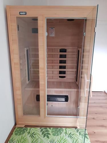 a wooden cabinet with a glass door in a room at Ferienhaus Relax Ranch in Hiltpoltstein