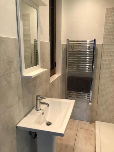 a bathroom with a white sink and a shower at Casa Elena in Camporgiano