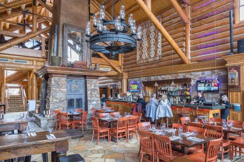 a restaurant with tables and chairs and a bar at 2 BR Condominium - Luxury Skiin out - on River to0 in Telluride