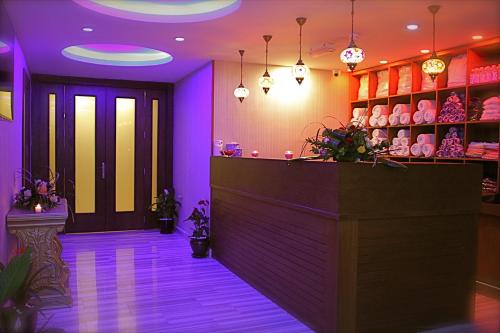a lobby with purple lighting and a counter at Ankawa Royal Hotel & Spa in Erbil