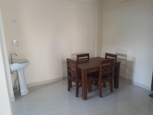 a dining room table with two chairs and a sink at Castle Dollars in Bengaluru