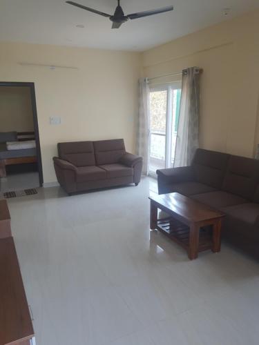 a living room with two couches and a coffee table at Castle Dollars in Bengaluru