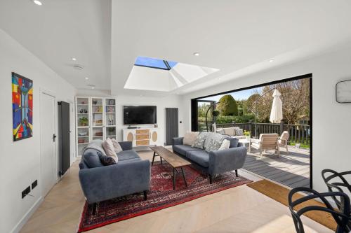 a living room with two couches and a tv at Luxury 5 bedroom Victorian home with Hot Tub in Blairgowrie