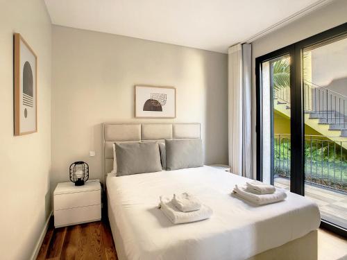 a bedroom with a bed with two towels on it at Sunlight Apartment by LovelyStay in Funchal