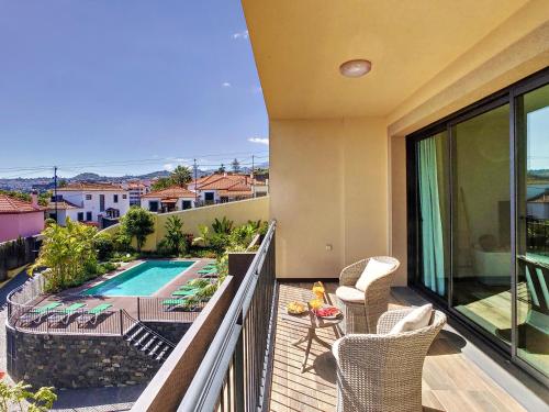 a balcony with a view of a swimming pool at Sunlight Apartment by LovelyStay in Funchal