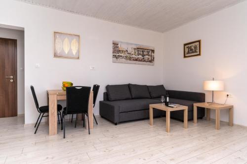 a living room with a couch and a table at Joseph - superior sea bay and mountain view in Cavtat