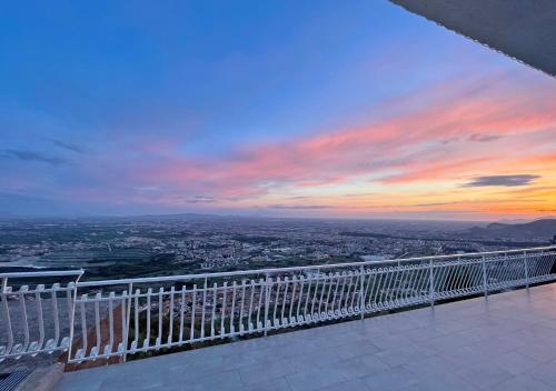a view of a city from a balcony at sunset at Super panoramic new apartment in Casertavecchia in Caserta