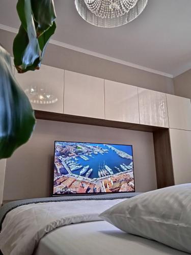 a bedroom with a flat screen tv above a bed at VIP Квартира Подобово Центр, 2 кімнати, Смарт ТВ, Документи in Rivne