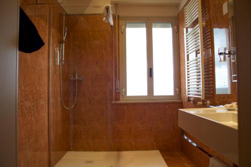 a bathroom with a shower and a sink at Parco dei Principi Boutique Hotel in Rimini