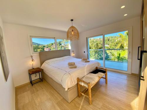 a bedroom with a bed and a large window at Villa De Oro in Calonge