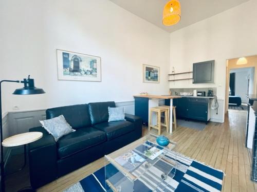 a living room with a couch and a table at Appartement Petit Messier in Senones