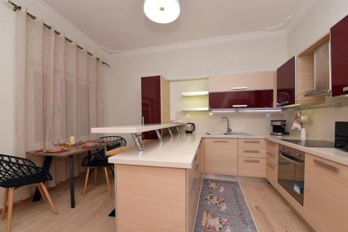 a kitchen with a table and a counter top at Nefeli House Syros in Ermoupoli