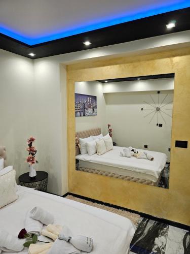 a room with two beds and a large mirror at Andjela Lux in Vrnjačka Banja