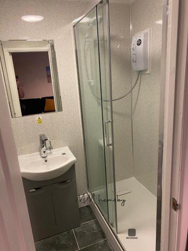 a bathroom with a shower and a sink and a mirror at MaterMolly Hemsby Chalet Hire 240 Belle aire beach road Hemsby NR29 4HZ in Hemsby