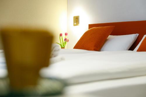 a hotel room with a bed and a vase of flowers at Boutique Hotel Piazza Grande in Locarno