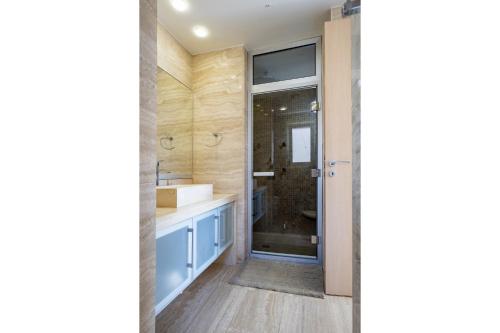 a bathroom with a sink and a shower at AAA SEAVIEW PANORAMA in Pervolia