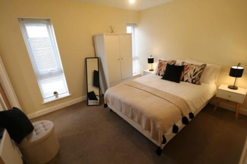 a bedroom with a bed and a chair and a window at The Loft - IH21ALL - APT 9 in Thornaby on Tees