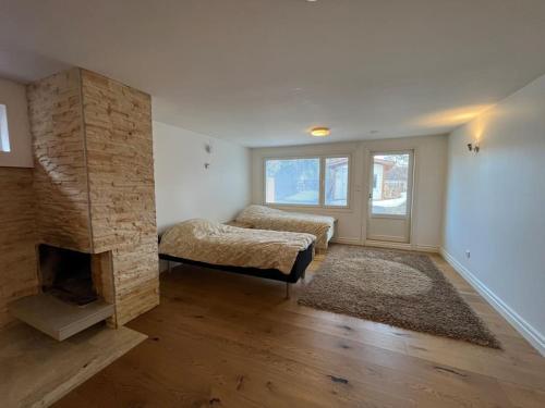 a living room with a fireplace and a couch at Stunning 5BR 16 Bed Home with Finnish Sauna & Jacuzzi 340 m2 in Tampere