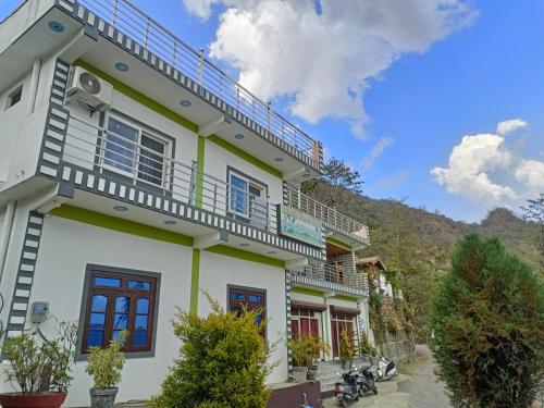 Cette maison blanche dispose d'un balcon. dans l'établissement Nature Villa, à Rishikesh
