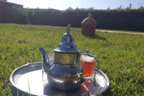 a tea pot sitting on a tray with a drink at Villa, piscine sans vis à vis et hammam privé. in Agadir Toudras