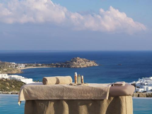 a table with towels and a view of the ocean at Ezio Bo Luxury Living in Mýkonos City