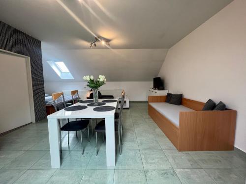a living room with a white table and a couch at Ubytování Zátiší 2 Olomouc in Olomouc
