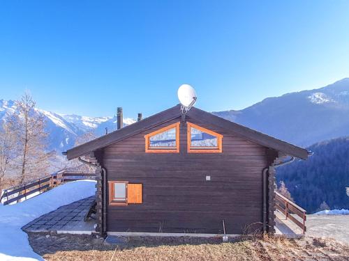 a log cabin with a satellite dish on the roof at Chalet Claire de Soleil in La Tzoumaz