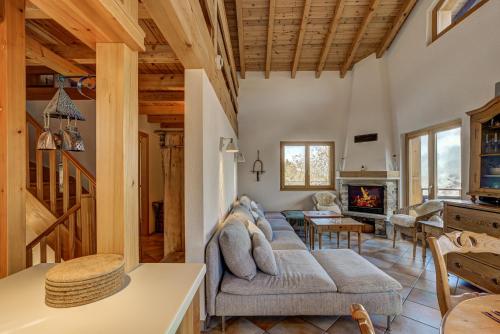 a living room with a couch and a fireplace at Chalet Claire de Soleil in La Tzoumaz