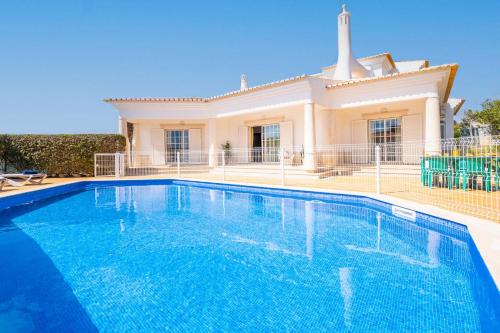 a villa with a swimming pool in front of a house at Villa Rose Bay by Algarve Vacation in Albufeira